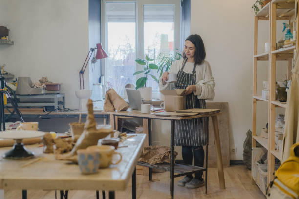 istock Female ceramist packing orders in her studio 1306643733