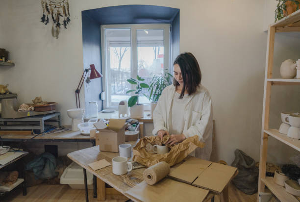 istock Female ceramist packing orders in her studio 1306643779