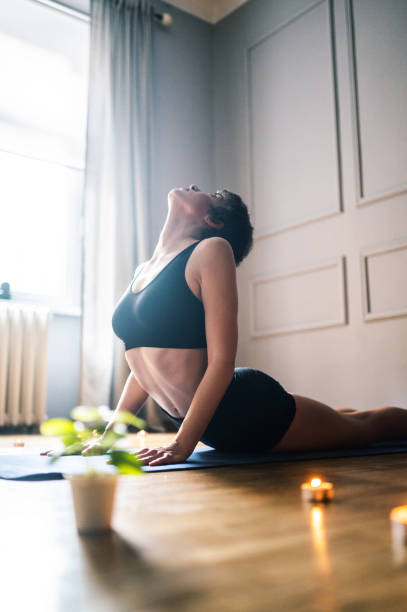 istock Young Woman Practicing Yoga At Home 1306644687