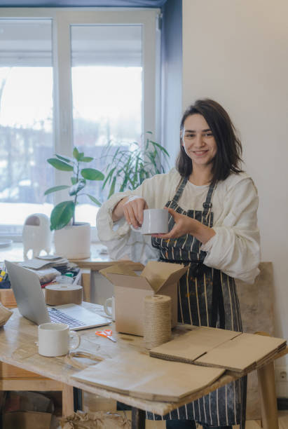 istock Female ceramist packing orders in her studio 1306646944