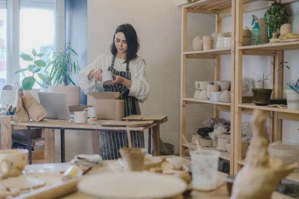 istock Female ceramist packing orders in her studio 1306646949