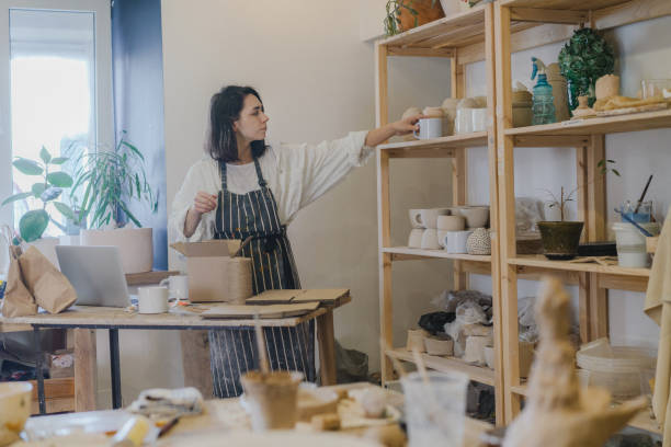 istock Female ceramist packing orders in her studio 1306647458