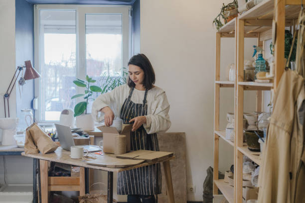 Female ceramist packing orders in her studio