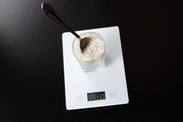 istock Glass with rice on electronic scales and spoon 1306650343