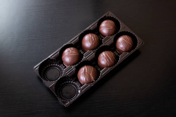 istock Chocolate candies in a box close up 1306650557