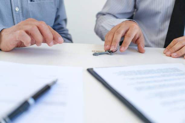 istock Sales manager giving advice application form document, considering mortgage loan offer for car and house insurance. 1306650615