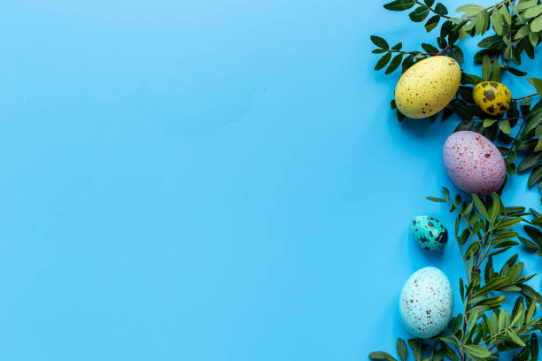 istock Happy Easter with colorful eggs and green branch, top view 1306651995
