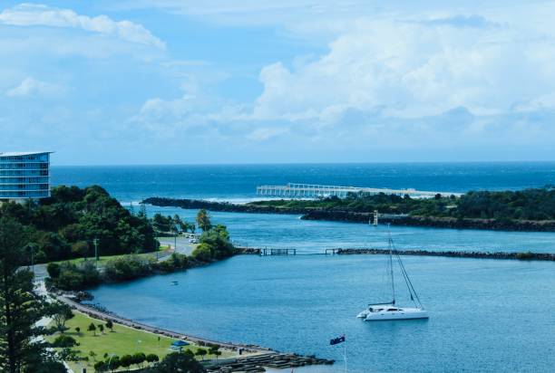 Blue Day at Tweed Heads River to Ocean Australia Horizontal landscape high up aerial view looking down to Tweed Heads River with view out to blue aqua turquoise ocean with promenade jetty yacht boat public park and apartment building from window Australia tweed stock pictures, royalty-free photos & images