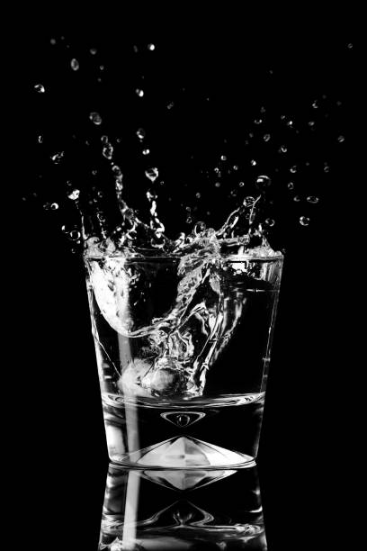 splash of water in a glass, splashes scatter in different directions. element concept water stock photo