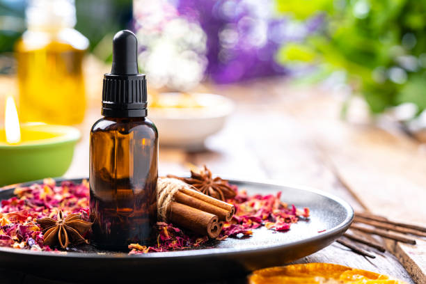 Aromatherapy: essential oil bottle on wooden table. Copy space