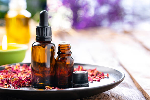 istock Essential oil bottles on wooden table. Copy space 1306657822