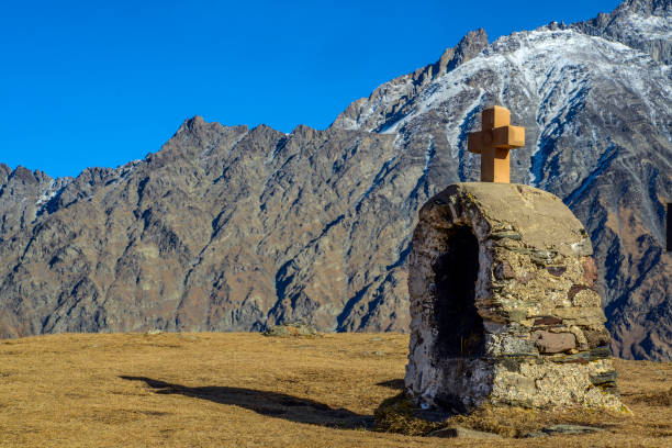 Cross in Kazbegi with view of caucasus.