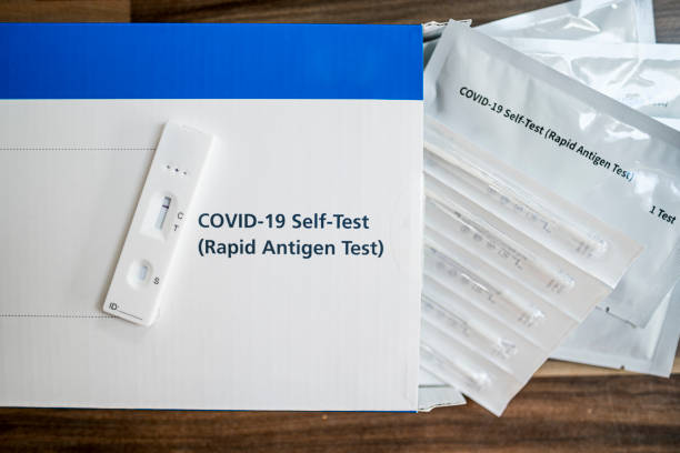 A close up of a lateral flow home testing kit A rapid antigen test or lateral flow home testing kit. antigen stock pictures, royalty-free photos & images