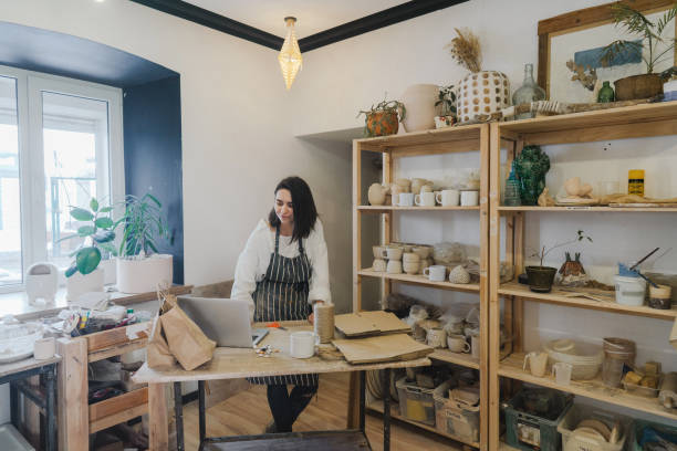 istock Female ceramist packing orders in her studio 1306660250