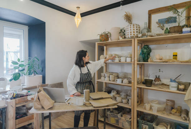 istock Female ceramist packing orders in her studio 1306660252