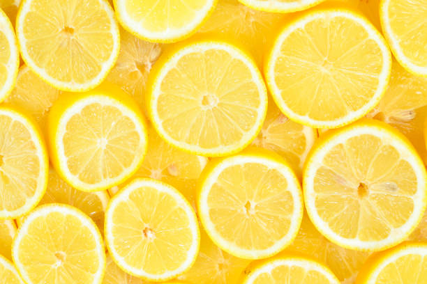 istock A slices of fresh juicy yellow lemons.  Texture background, pattern. 1306660369