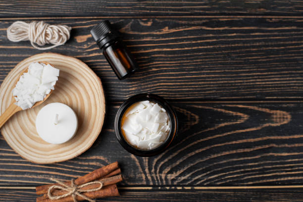 istock Basic set for home-made natural white eco soy wax candles in glass, wick, perfume. Idea for a hobby, business. Making trendy diy candles without harm to health on wood background. 1306660801