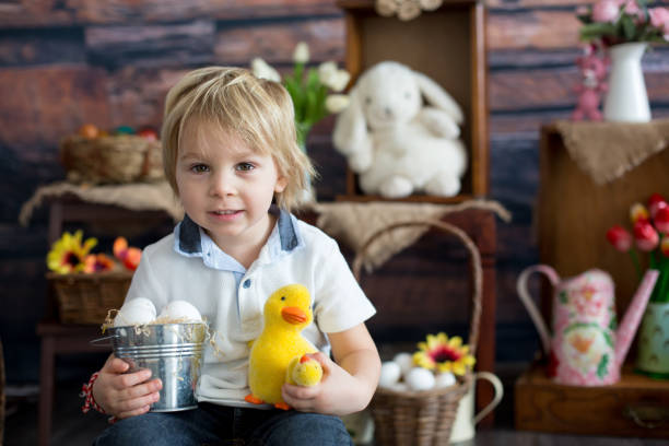 istock Cute toddler blond child, boy with easter decoration 1306663024