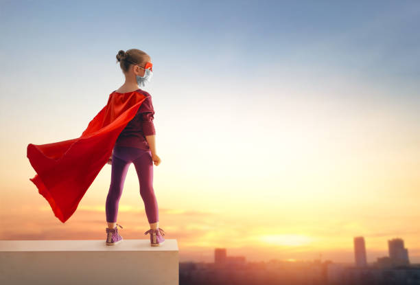 istock Little child playing superhero and wearing face mask 1306663498