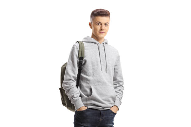 istock Teenage schoolboy posing with hands in pockets 1306664632