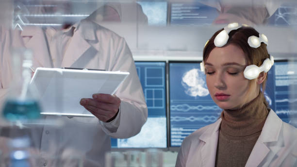 istock Working on brainwave scanning headset. Woman wearing sensors 1306664805