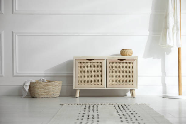istock Wooden commode near white wall in room. Interior design 1306665949