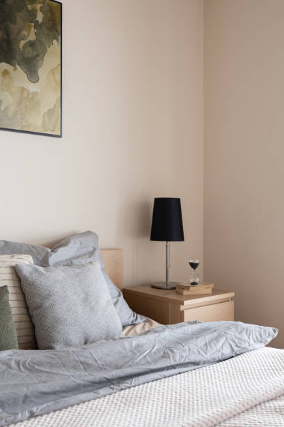 istock Black lamp on wooden bedside table 1306668177