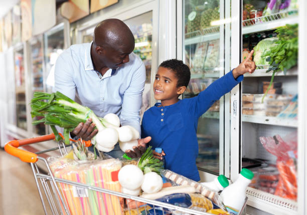 istock man with son choosing fresh greens and vegetables 1306668211