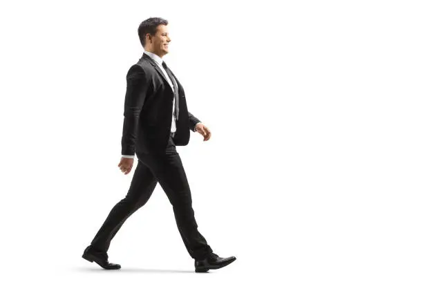 Photo of Full length profile shot of a businessman walking