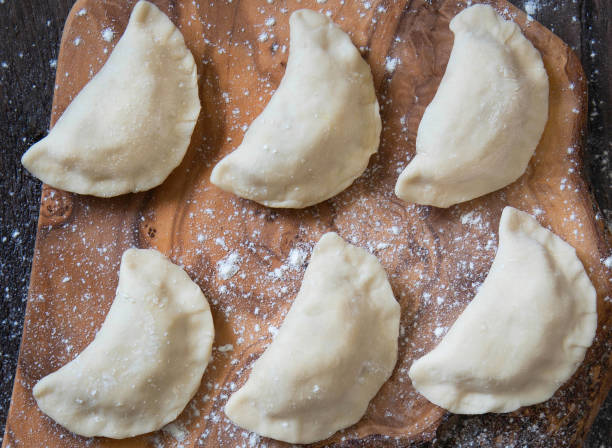 Homemade raw dumpling with potatoes. Preparation dumplings with mashed potatoes . Homemade raw dumpling with potatoes. Preparation dumplings. Closeup pierogi stock pictures, royalty-free photos & images