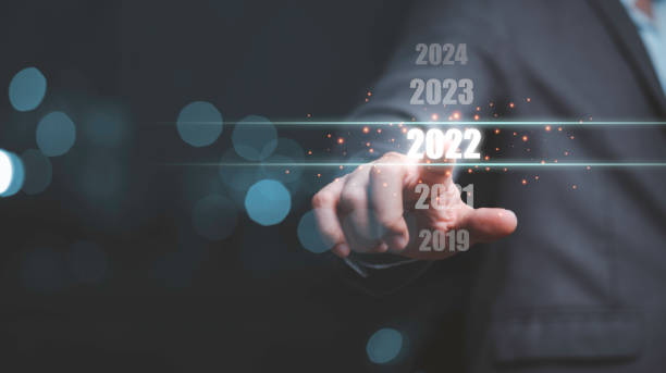 Businessman touching on number 2022 for preparation and change to merry Christmas and happy new year. Businessman touching on number 2022 for preparation and change to merry Christmas and happy new year. calculating stock pictures, royalty-free photos & images