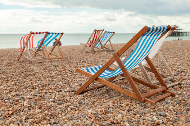 istock Empty red and blue striped deck chairs in Brigthon, UK. 1306670119