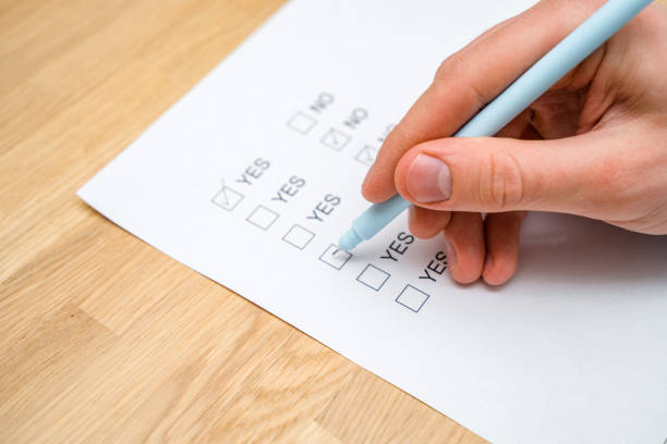 istock A survey form with yes or no answer options. Questionnaire on white paper, checkboxes ticked 1306670426