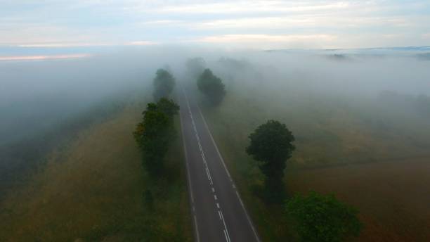 istock Flying Over Road Fog Mist Rural Countryside 1306670574