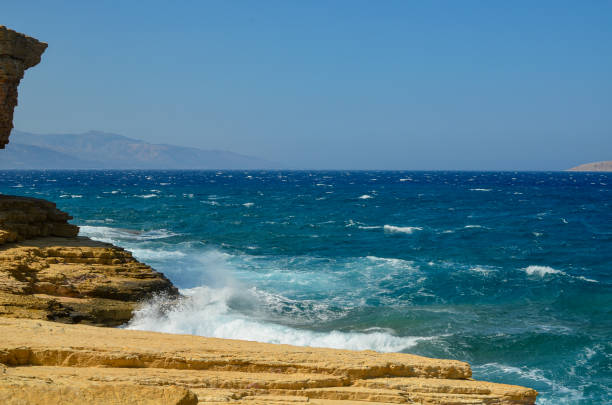 istock Rocks, turquoise sea water, and blue Cycladic sky 1306670911