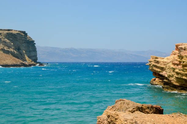 istock Rocks, turquoise sea water, and blue Cycladic sky 1306671579