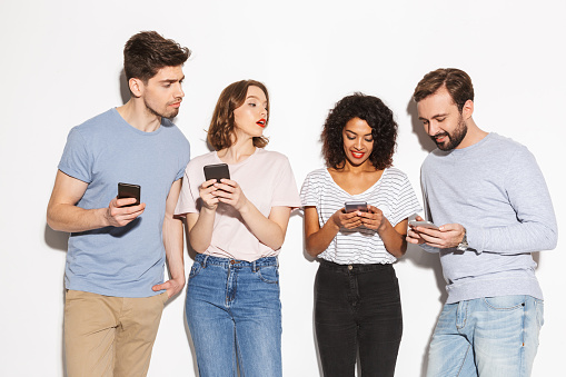 Group of modern multiracial people using mobile phones isolated over white background