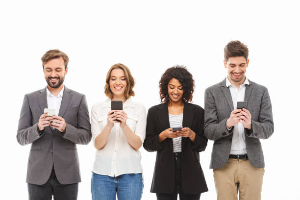 istock Group of smiling young business people using mobile phones 1306674029