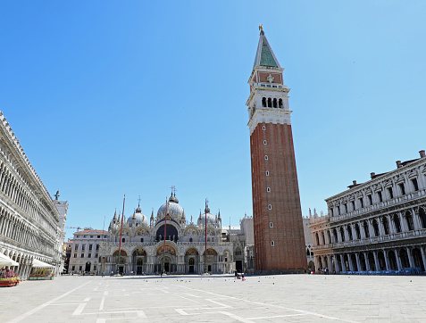 very few people in the deserted Square of Saint Mark  in Venice during the lockdown caused by the coronavirus epidemic in Italy