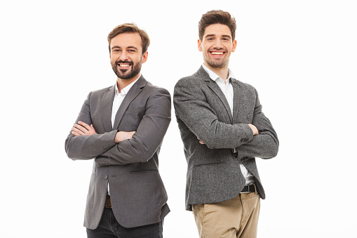 Portrait of a two confident business men standing with arms folded isolated over white background