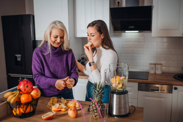 istock Mother and Daughter making smoothie 1306683094