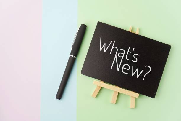 istock Text What's New on small blackboard with pen on pastel colour background 1306683299