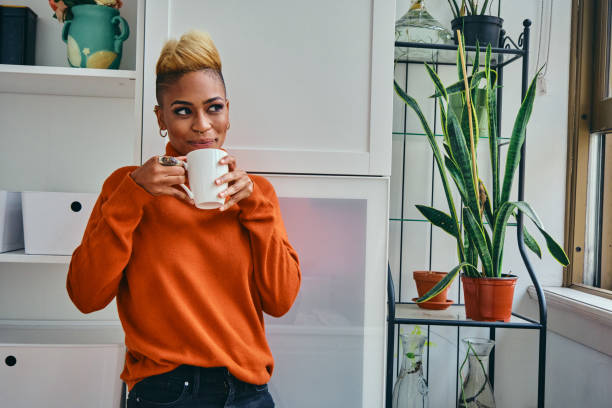 istock Contemplated Female Hipster Having Coffee At Home 1306687232