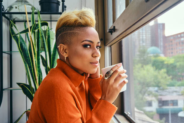 istock Thoughtful Female Hipster Having Coffee At Window 1306687247