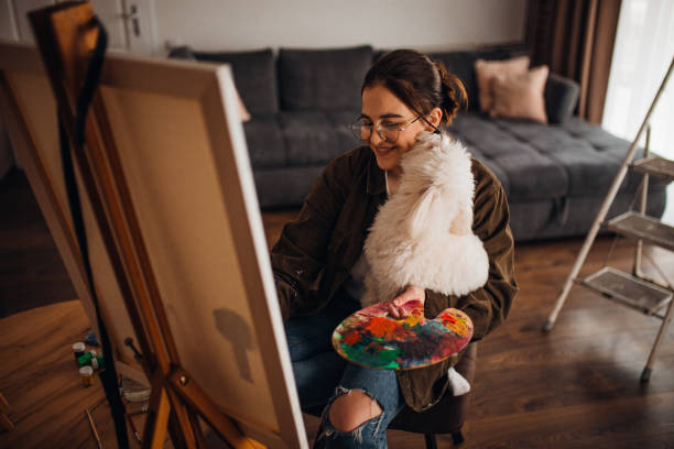 istock Girl painting on canvas 1306687548