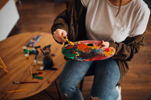 istock Girl painting on canvas 1306688471