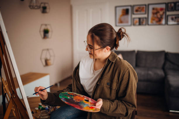istock Girl painting on canvas 1306688533