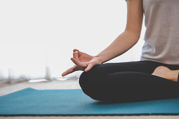 istock Training at Home. Sporty woman doing yoga plank while watching online tutorial on laptop exercising in living room. 1306690727