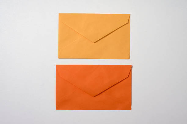 istock yellow and orange envelopes on white background 1306691753
