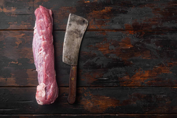 오래된 정육점 칼로 생 돼지 고기 필레, 오래된 어두운 나무 테이블 배경에, 상단 보기 평면 누워, 카피 스페이스와 텍스트 공간 - fillet meat portion fillet steak 뉴스 사진 이미지